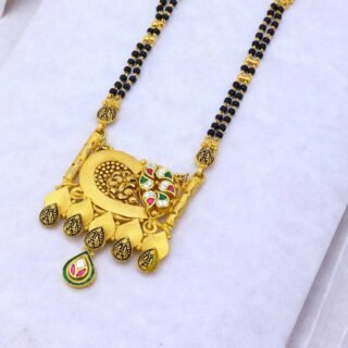 Floral designer mangalsutra with black beads and colorful stone pendant .