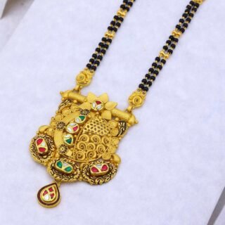Traditional designer mangalsutra with ornate gold-style pendant and black beads.